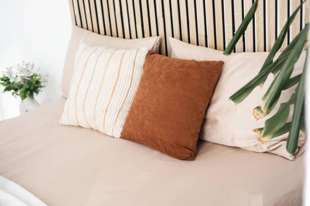 Decorative pillows enhance cozy bedroom ambiance with modern touch