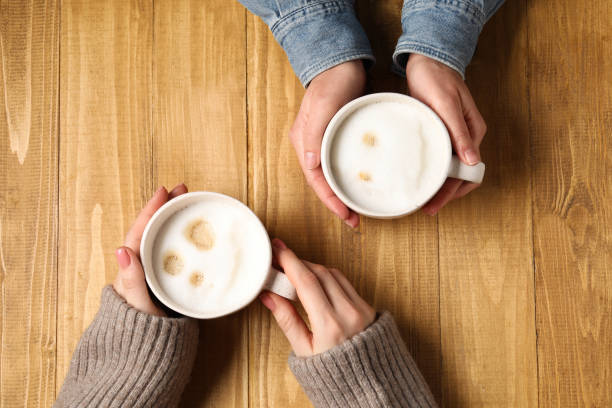istock Women having coffee break at wooden table, top view 2196841682