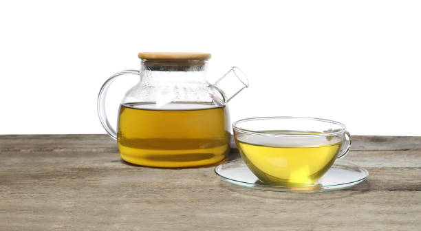 istock Refreshing green tea in cup and teapot on wooden table against white background 2196841768