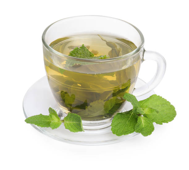 istock Fresh green tea in glass cup, mint and saucer isolated on white 2196841770