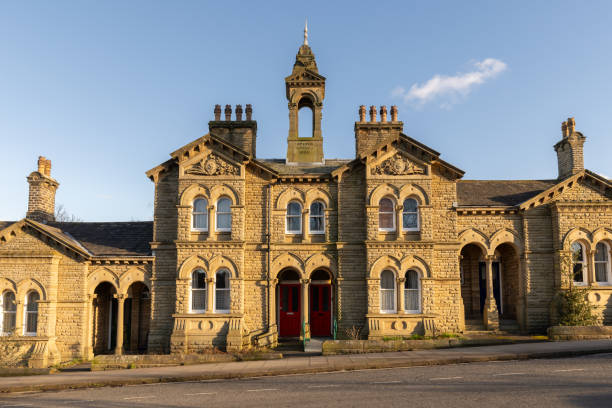A row of four separate homes, which are traditional almshouses in Saltaire, Bradford, UK