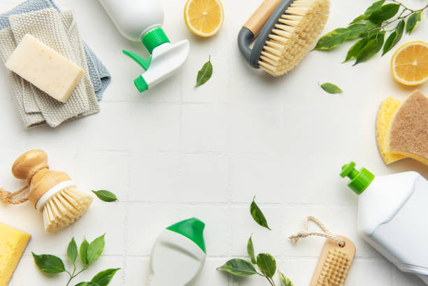 istock Eco friendly cleaning products and lemon on white tile background creating frame 2196843385