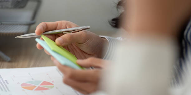istock Close up of a business professional analyzing notes and data charts. 2196848503