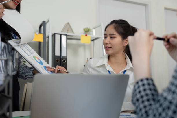 istock Diverse business team reviewing charts and graphs during a meeting. 2196848540