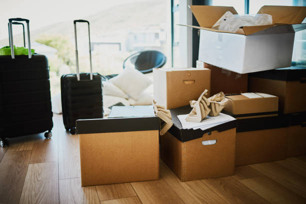 istock Packed Boxes and Suitcase on Hardwood Floor, Ready for Moving Day 2196848874