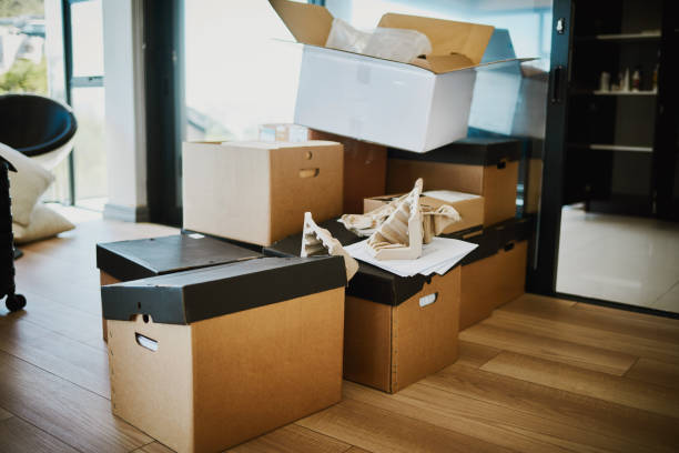 Packed Cardboard Boxes Ready for Relocation on Hardwood Floor stock photo