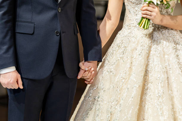 istock Man and a woman are holding hands 2196852187