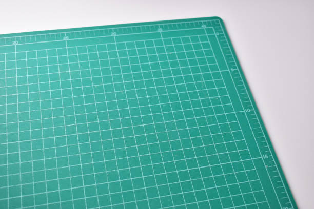 istock green cutting mat board on white background with line and scale measure guide pattern for object art design, tool equipment of diy craft work 2196854366