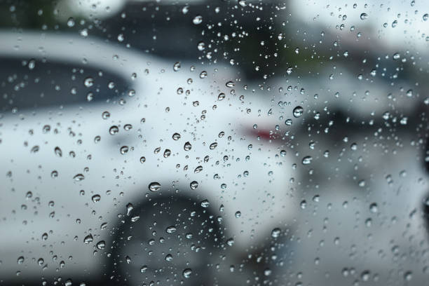 istock water drop on mirror in defocused car parking background 2196854472