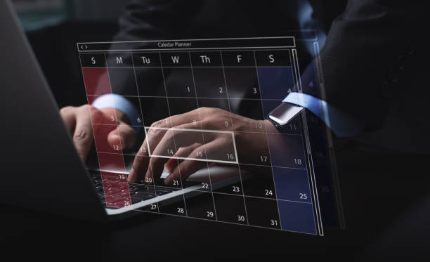 istock Business event planning, calendar agenda work schedule concept. Businessman using laptop computer with monthly calendar planner, workflow plan, and organize schedules. Work time management 2196854641