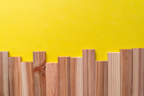 Wooden boards lined up on a yellow background