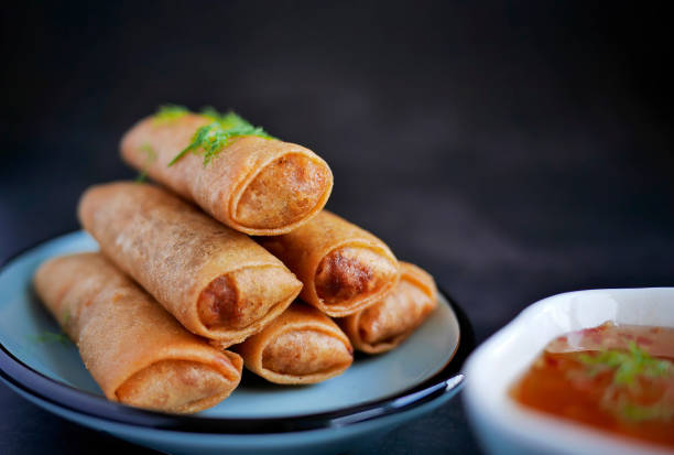 istock Deep fried spring roll in golden brown color, served in a blue oval shape plate, famous local street food in Thailand, food industry concept 2196861272