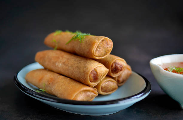 istock Deep fried spring roll in golden brown color, served in a blue oval shape plate, famous local street food in Thailand, food industry concept 2196861276