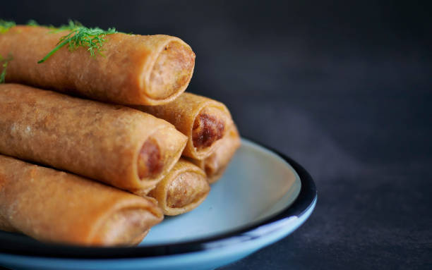 istock Deep fried spring roll in golden brown color, served in a blue oval shape plate, famous local street food in Thailand, food industry concept 2196861290