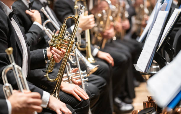 istock Details of musicians playing horn instruments in orchestra 2196862031