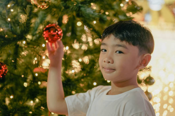 Boy with Christmas tree in the night lights