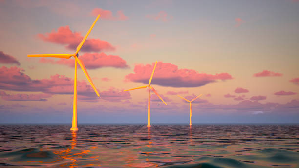 istock Three wind turbines located in the sea at sunrise, three dimensional digitally generated image 2196863386
