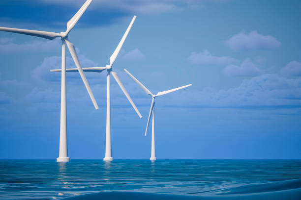 Aerial view of wind turbines , a prawn farm and water aerators at sunset