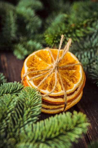 Dried oranges on the rustic wooden background. Christmas mood. Selective focus. Shallow depth of field.