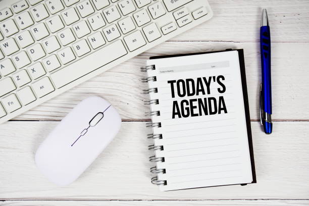 istock Today's Agenda text on notepad with keyboard and optical mouse on wooden background 2196867271