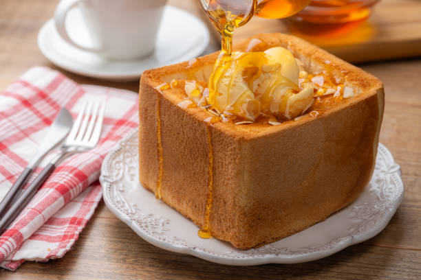 istock Pouring Honey Over Thick Honey Toast 2196867386