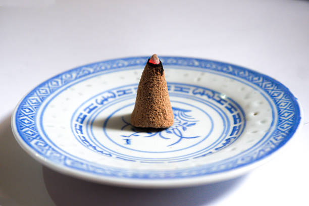 istock an incense cone burning on a small plate isolated on a white background 2196867403
