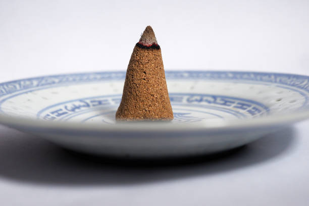 istock a burning incense cone on a small plate isolated on a white background 2196867563