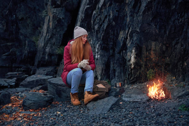 istock Traveler sitting near bonfire alone 2196868596