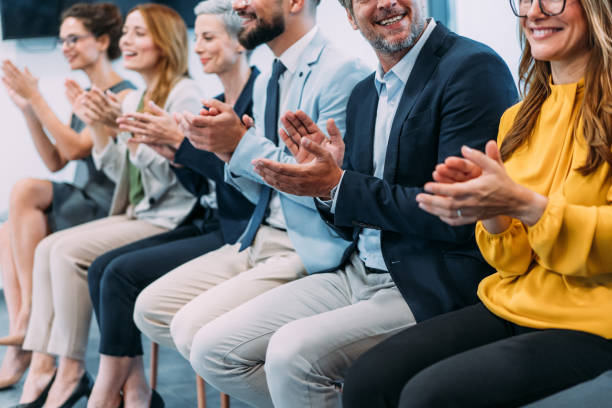 istock Businesspeople applauding during a seminar in conference hall. 2196870939