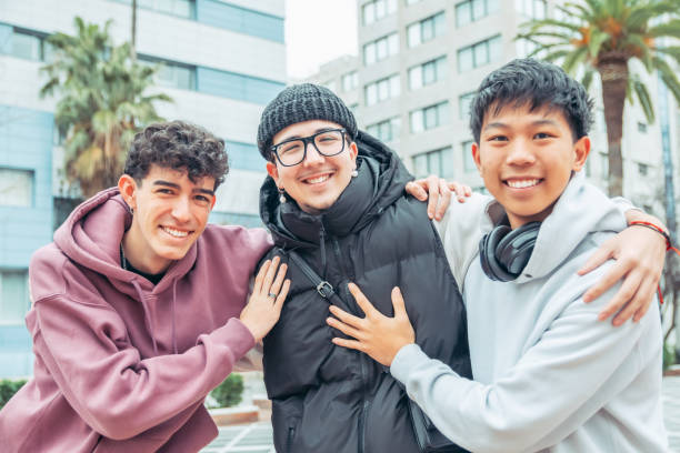 istock Multicultural male college students sharing warm group hug, expressing close friendship and camaraderie on university campus 2196871698