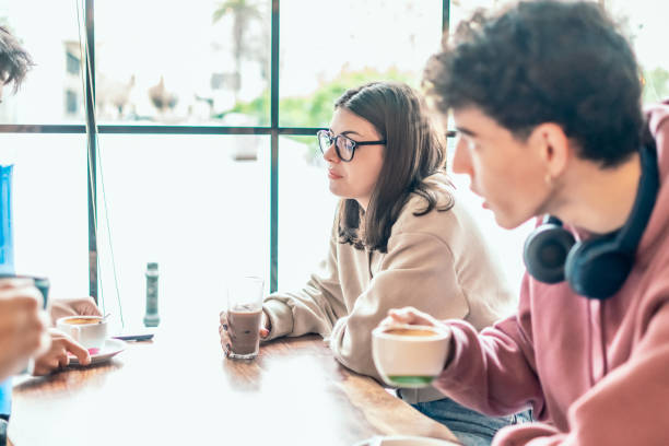 istock Diverse college students relaxing together, sipping coffee and engaging in animated conversation, building connections at local cafe 2196871750