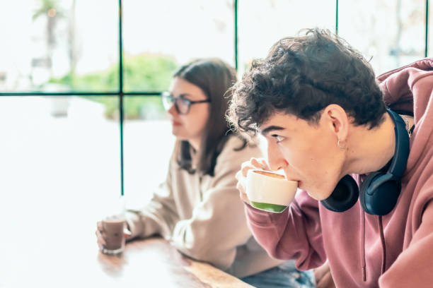 istock College students relaxing over coffee, sharing study break moment in cozy cafe setting, embodying friendship and camaraderie 2196871753