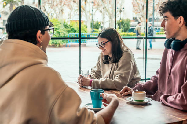 istock College students relaxing at cafe table, enjoying coffee break, sharing conversation and laughter during study downtime 2196871760