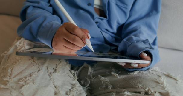istock A woman uses a tablet at home 2196873178