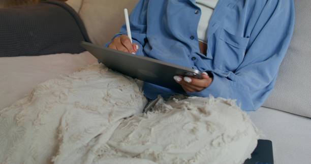 istock A woman uses a tablet at home 2196873184