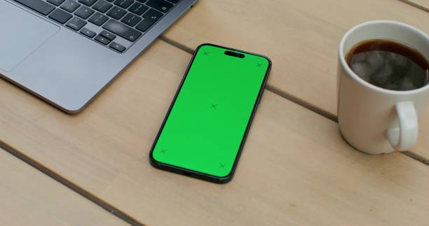 istock A mobile phone with green screen is on the table 2196873732
