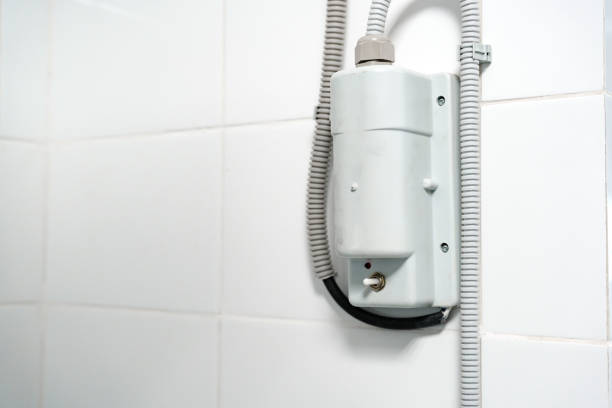 istock Electric shower unit mounted on tiled bathroom wall showing design features and installation details 2196874404