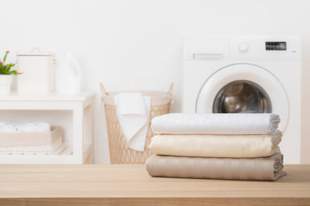 istock Stack of clean folded textile duvet covers on blurred laundry room background 2196875533