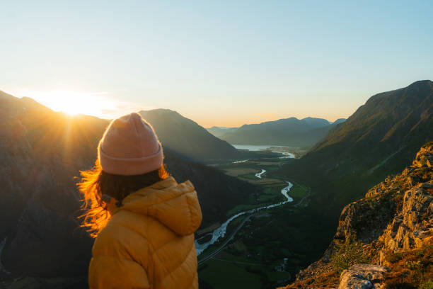 Woman exploring the great outdoors in remote location in Norway at sunset