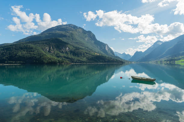 Boat on idyllic turquoise lake in Norway