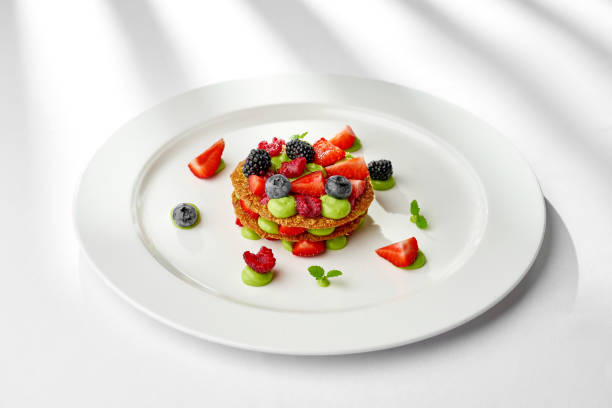 istock A vibrant and refreshing mille-feuille dessert, layered with fresh berries and a light cream. The dessert is garnished with a sprig of mint, creating a visually appealing and appetizing composition 2196879245