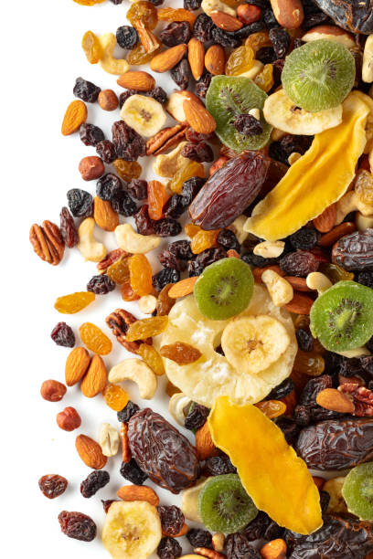 istock Dried tropical fruits, nuts, and raisins isolated on white. 2196879894