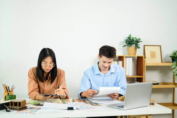 istock Creative team of interior designers working together in a modern office 2196880763