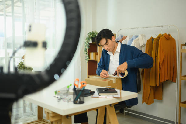 istock Young entrepreneur packing order for delivery in a stylish home office 2196880839