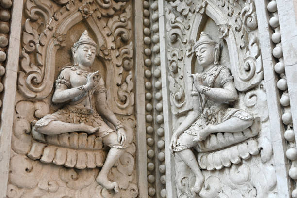 Ancient Statue Craving on the wall at the temple in Thailand