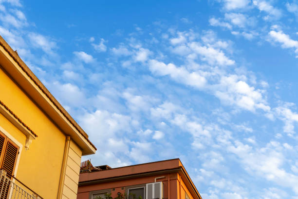 cut view on orange houses and deep blue and cloudy sky
