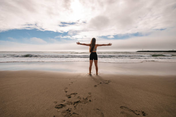 istock Woman embracing the ocean 2196888410
