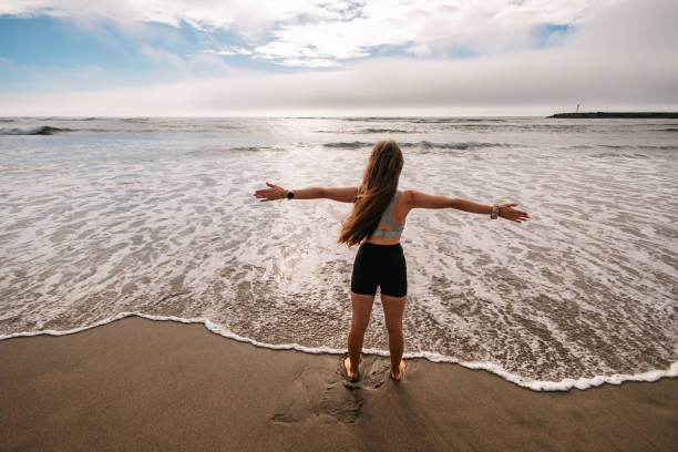 istock Woman embracing the ocean 2196888414