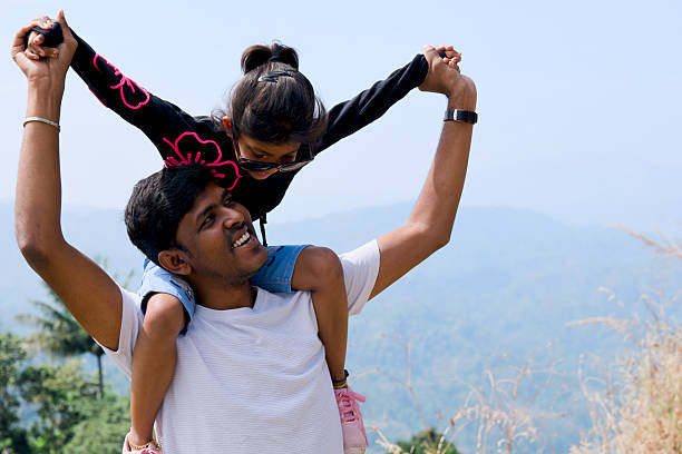 istock Father Carrying Daughter on Shoulders atop Mountain 2196889182