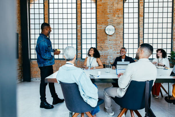istock Diverse team engaged in a collaborative meeting around a boardroom table in a modern office setting 2196894039